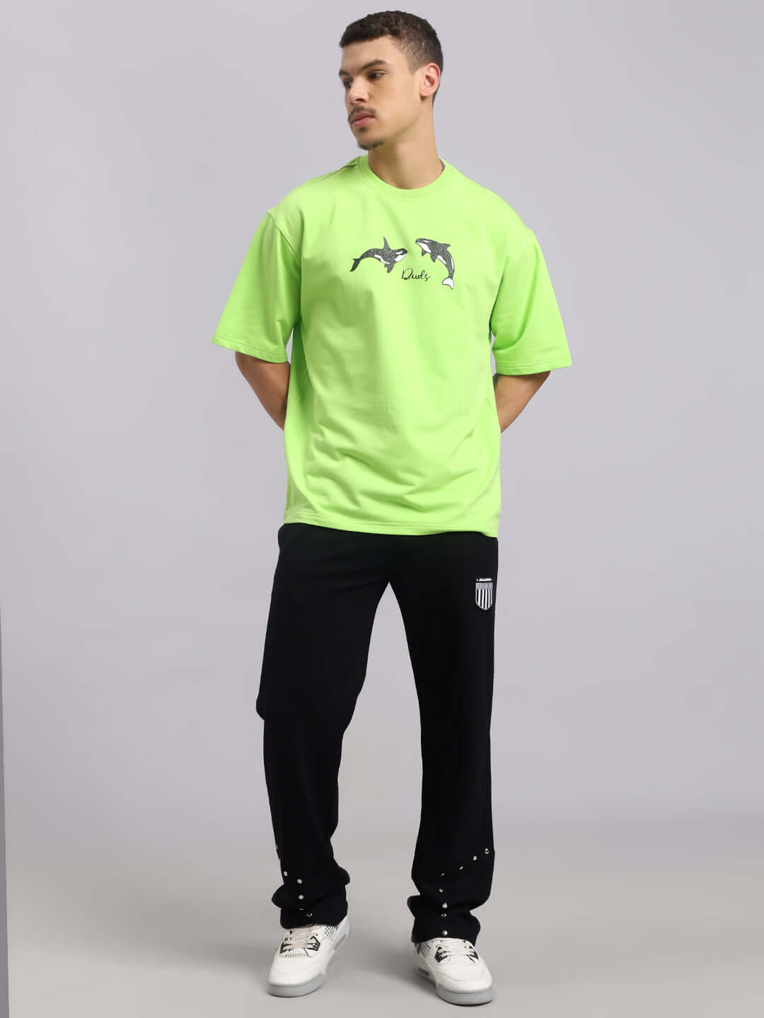 Model wearing Stunner Relaxed Fit Jogger in black paired with a bright green T-shirt, demonstrating casual style for men.
