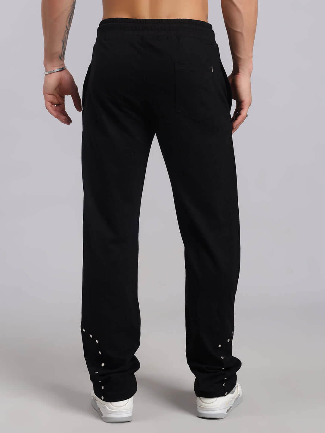 Person wearing black Stunner Relaxed Fit Jogger, showcasing back view with stylish design and comfortable fit.