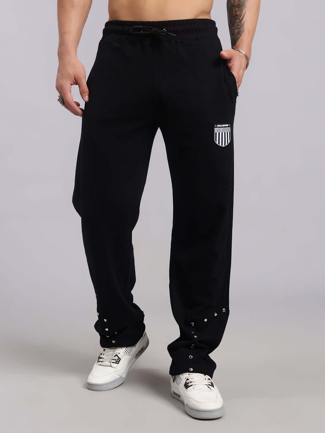 Model wearing Stunner Relaxed Fit Black Joggers by DUDS, featuring custom fit option for personalized comfort, made to order.