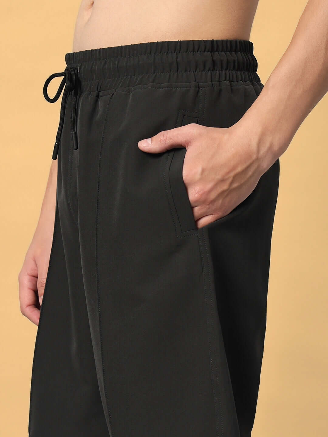 Model wearing dark grey sturdy front plated shorts with drawstring, highlighting pocket details.
