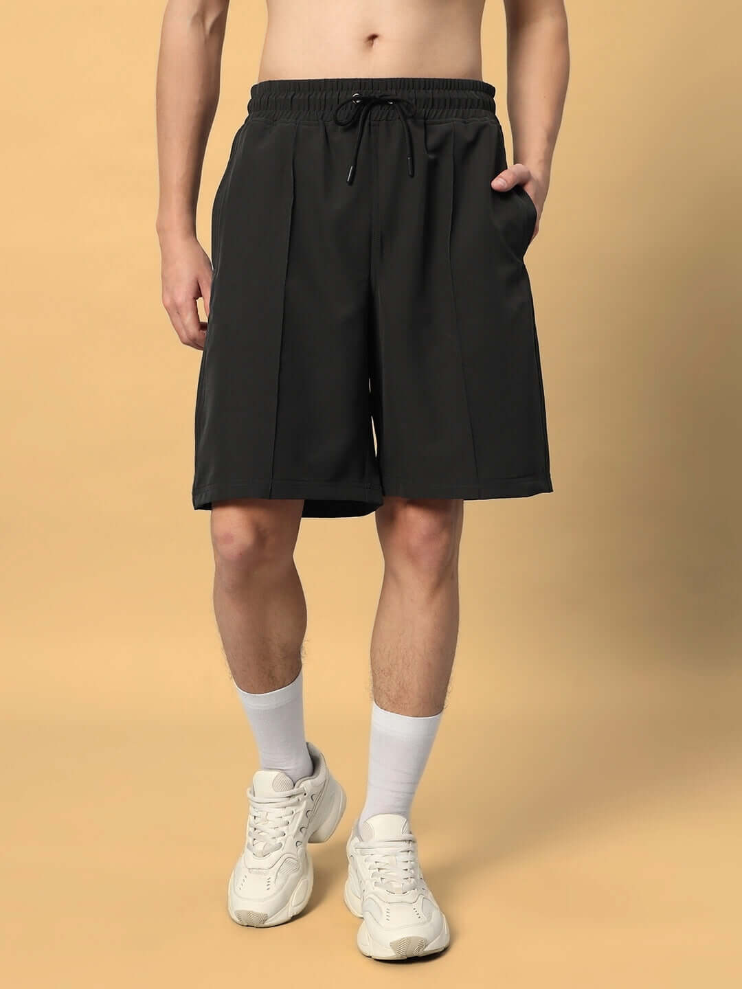 Model wearing sturdy front plated shorts in dark grey with custom fit option, available for prepaid orders, handmade for a perfect fit.