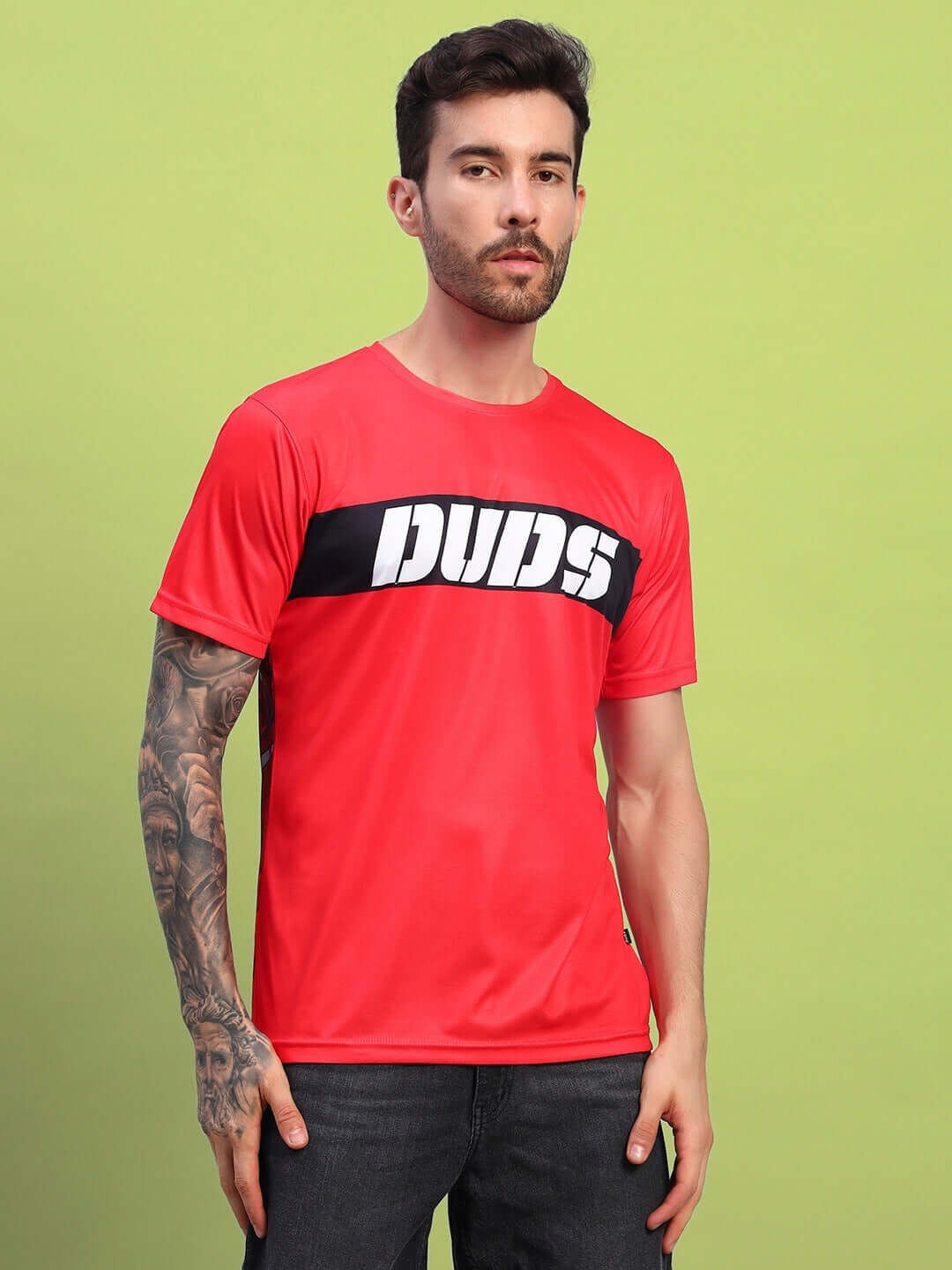 Model wearing a red stylized leopard printed T-shirt made of sports polyester fabric, suitable for casual wear.