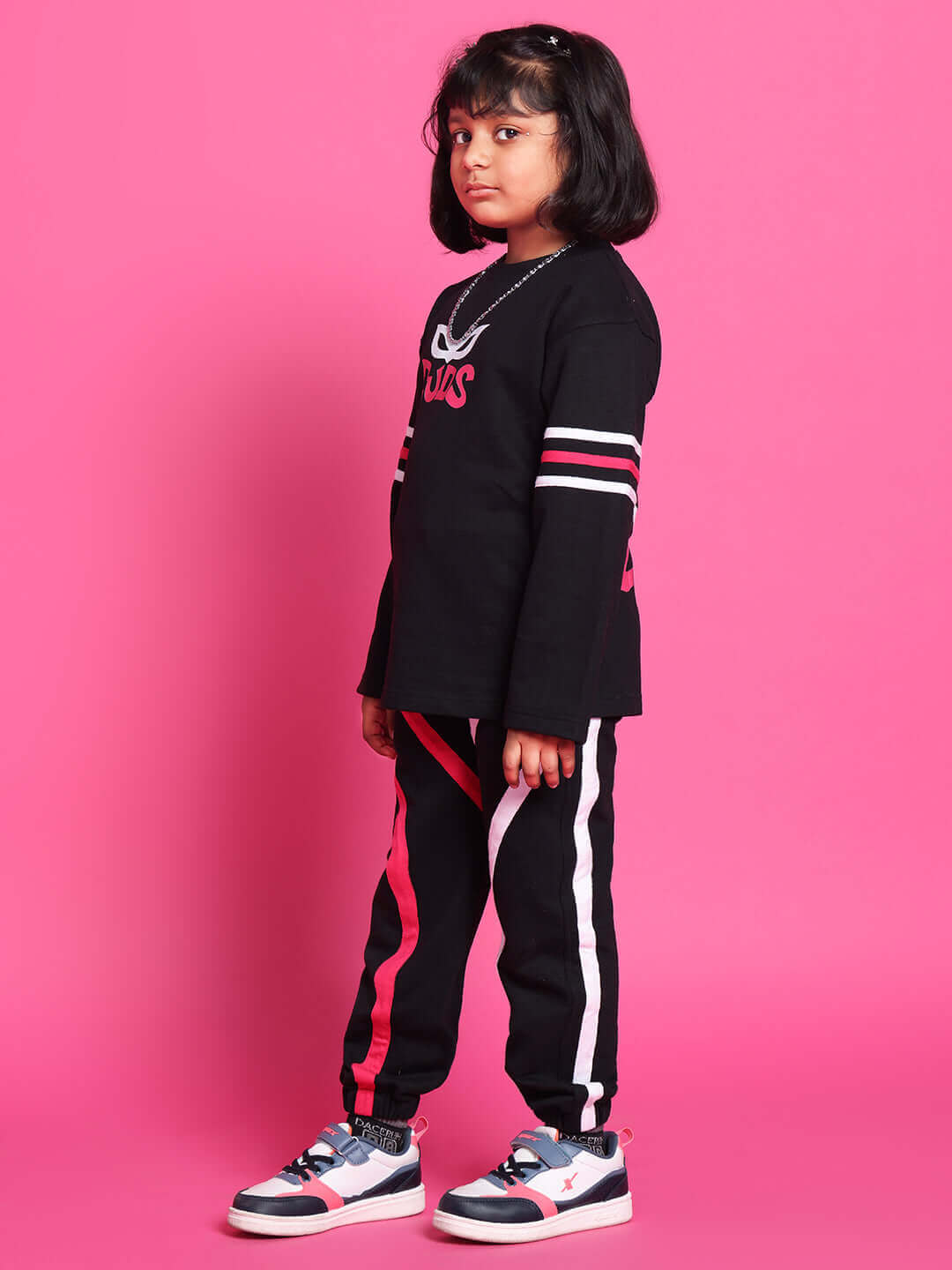 Child modeling SUPER CHAMP black co-ord set for boys & girls, featuring premium cotton French terry fabric. Ideal for casual wear.