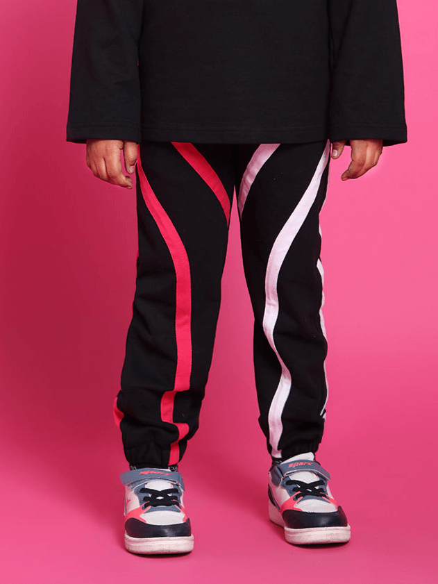 Child wearing black Super Champ Jogger with red and white stripes, suitable for both boys and girls, made to order by DUDS. Custom fit available.