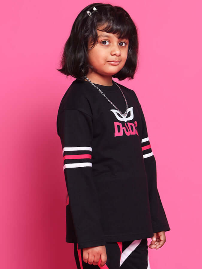 Child wearing SUPER CHAMP OVER-SIZED SWEATSHIRT FOR BOYS GIRLS BLACK on pink background