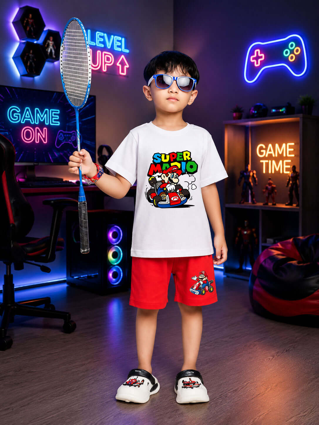 Boy wearing SUPER MARIO COOL SHORTS FOR BOYS GIRLS RED and a t-shirt, playing with a badminton racket.