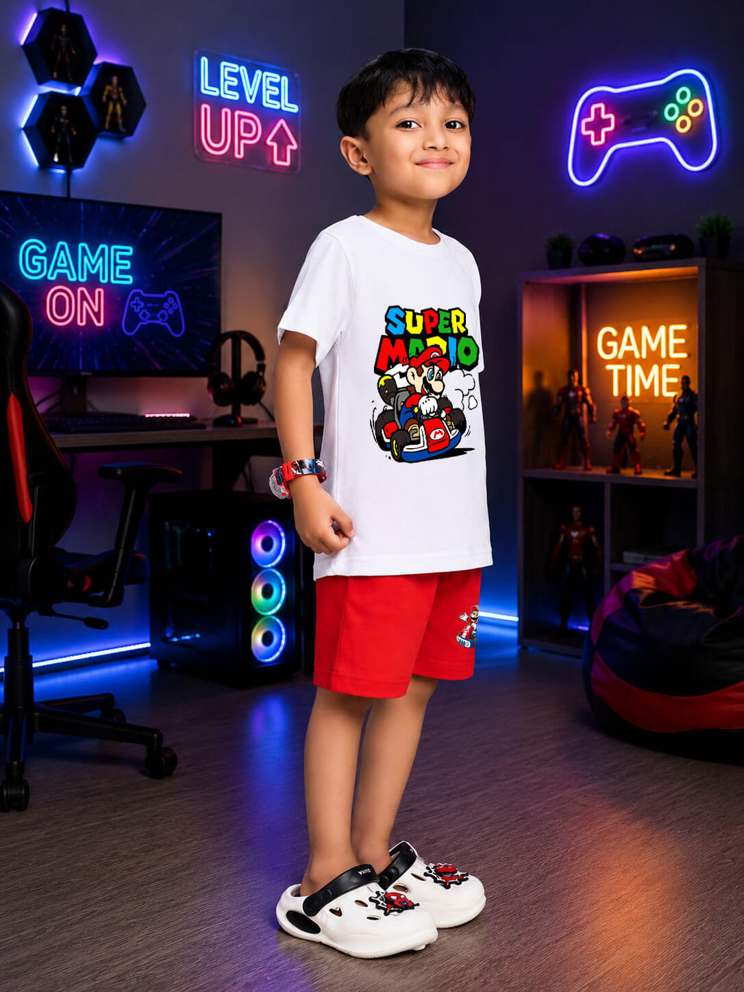 Boy wearing SUPER MARIO GRAPHIC CO-ORD FOR BOYS GIRLS WHITE RED in a vibrant gaming room.