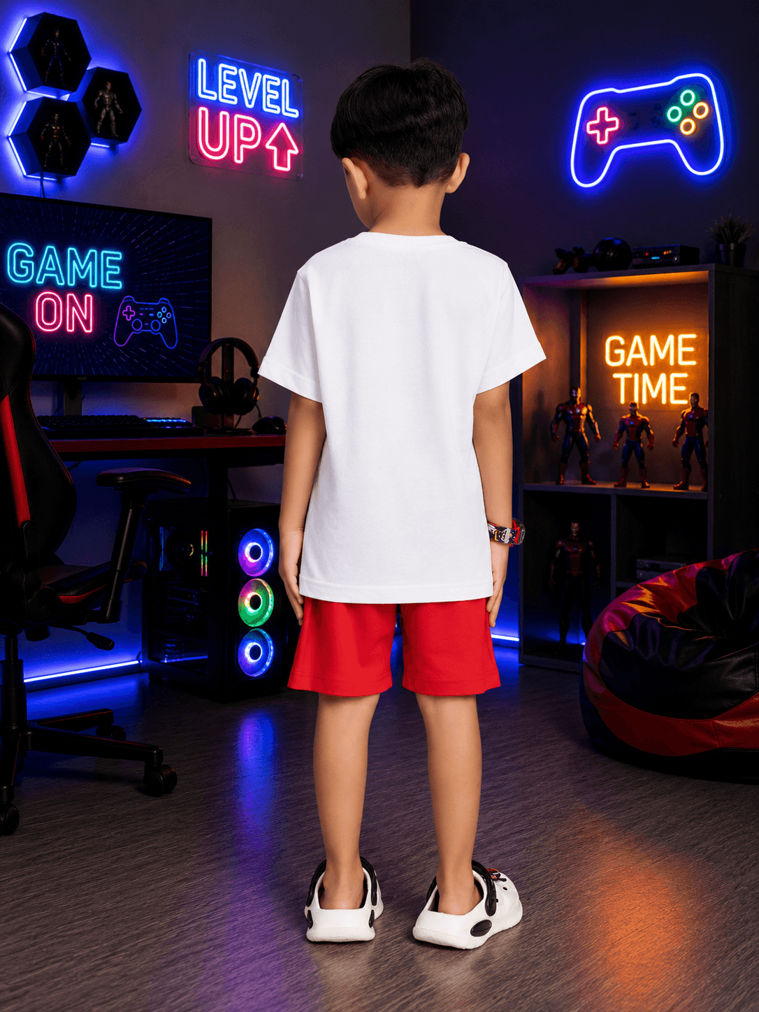 SUPER MARIO GRAPHIC CO-ORD FOR BOYS GIRLS WHITE RED, child wearing white shirt and red shorts in gaming room.