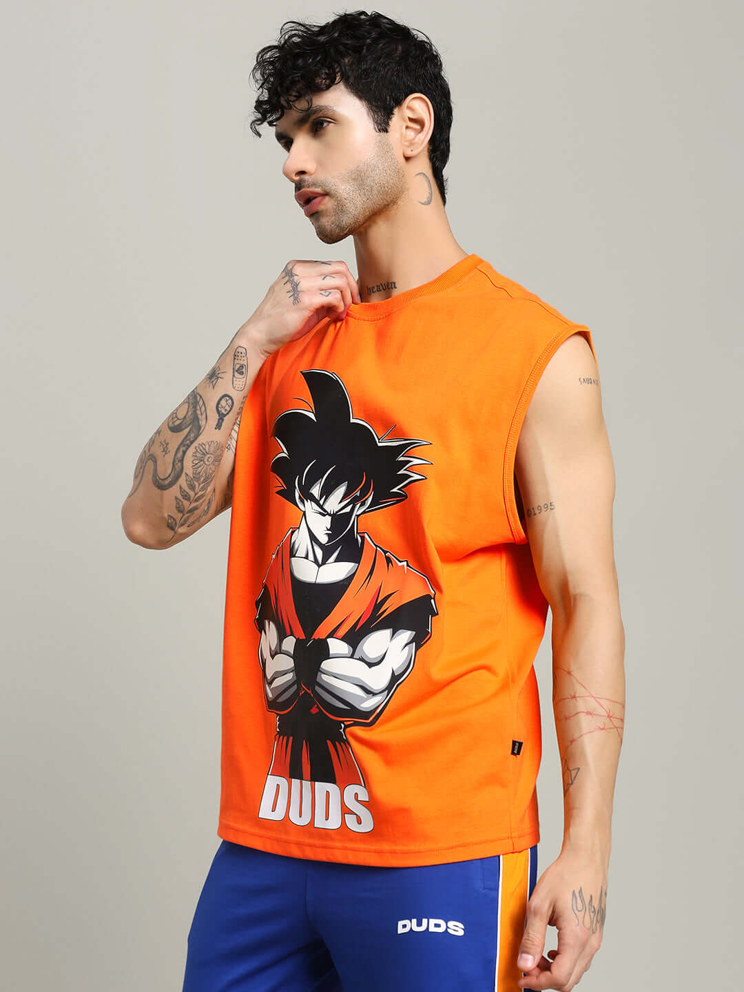 Orange SUPER SAIYAN gym t-shirt featuring anime character, perfect for custom size orders, displayed on a model with tattoos.