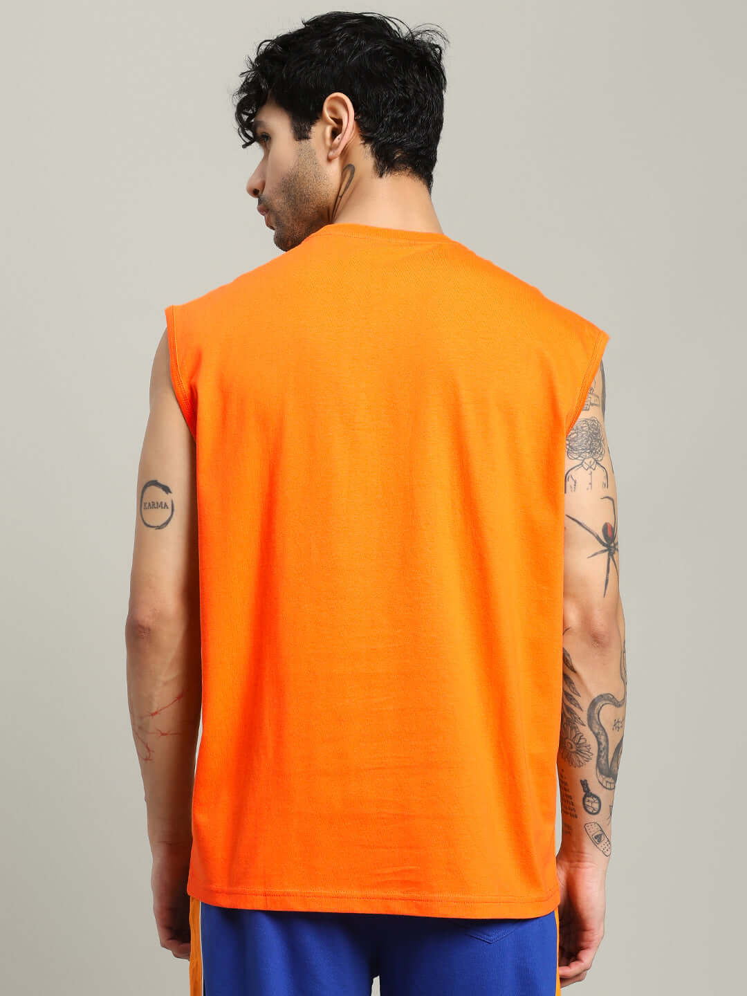 Back view of a wearable orange SUPER SAIYAN GYM T-Shirt, showcasing sleeveless design, ideal for fitness enthusiasts.
