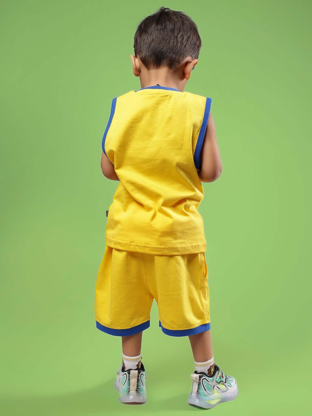 Child wearing SUPER HERO CO-ORD FOR BOYS & GIRLS YELLOW outfit, showcasing bright, comfortable design, perfect for kids' playful adventures.