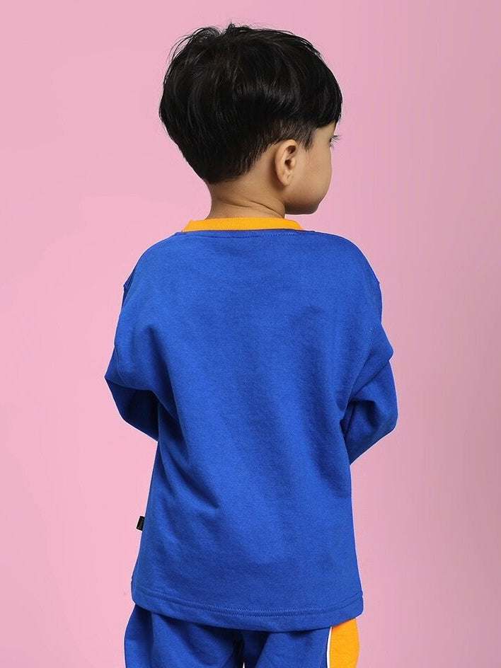 Child wearing the Super Saiyan Sweatshirt for Boys and Girls Blue showcasing the back view against a pink background.