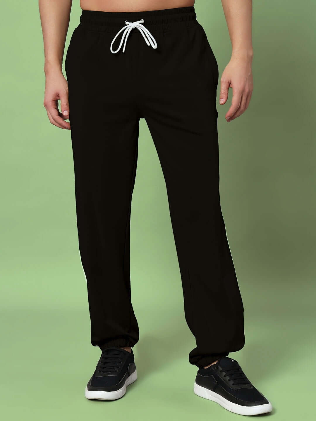 Model wearing SUPERB RELAXED PANT JOGGER in black, custom-fit option available, made to order by DUDS.