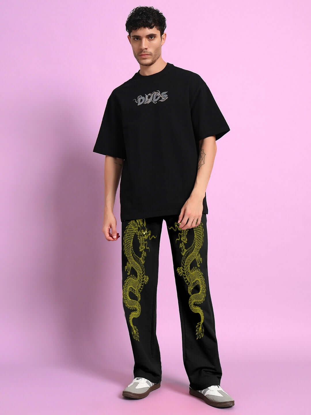 Model wearing SUPREME DRAGON PRINTED RELAXED FIT JOGGER BLACK with bold dragon print for modern streetwear.