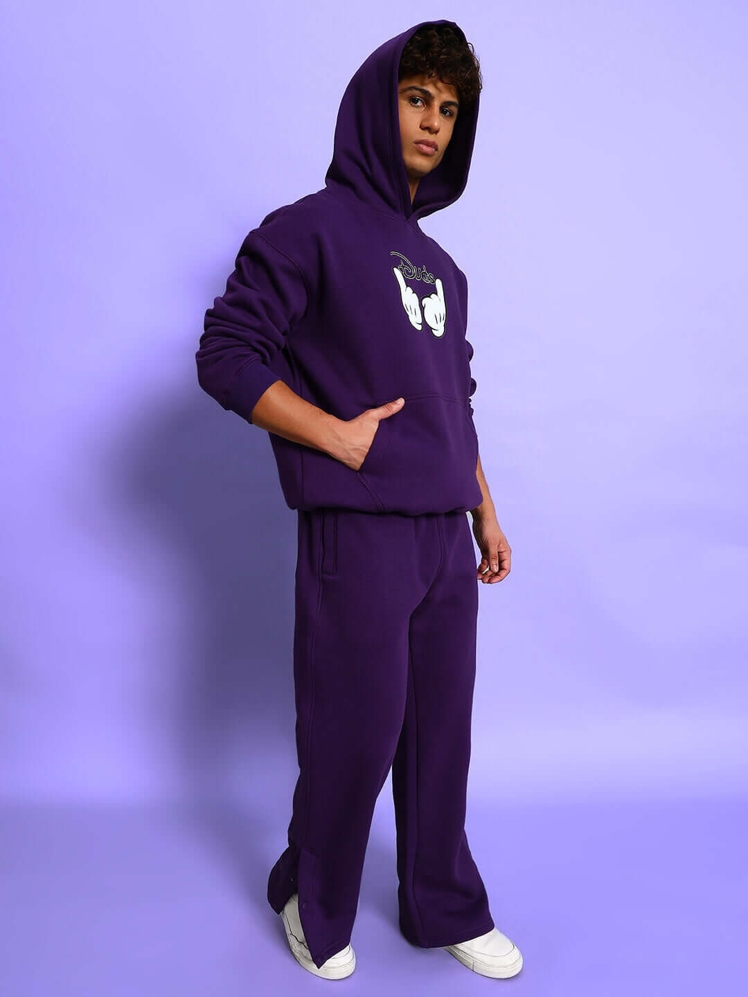 Model wearing SUPREME COTTON FLEECE HOODIE PURPLE against a purple background, showcasing premium comfort and vibrant streetwear style.