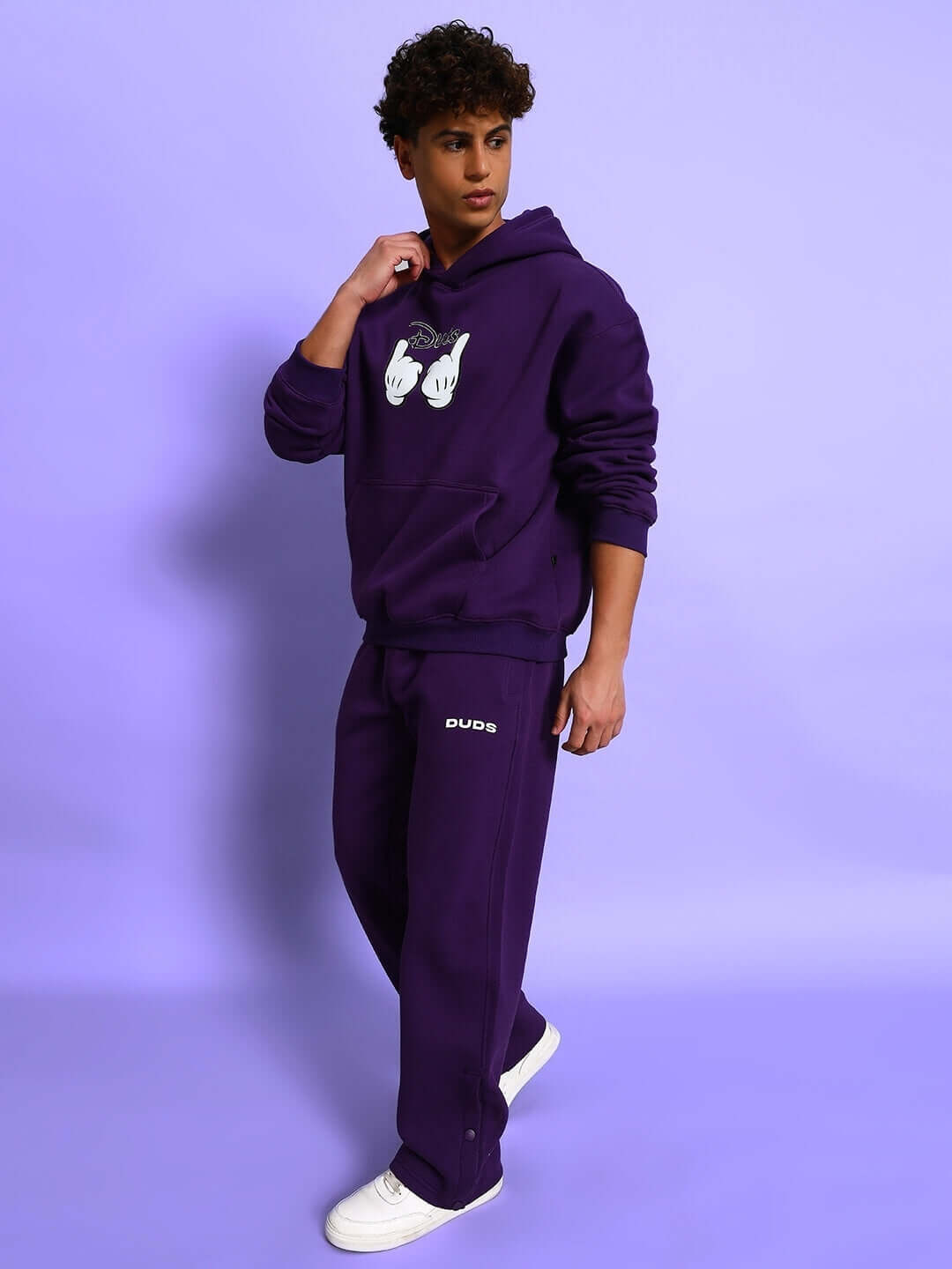 Model wearing SUPREME COTTON FLEECE CO-ORD PURPLE, featuring a relaxed-fit hoodie and joggers, perfect for streetwear fashion.