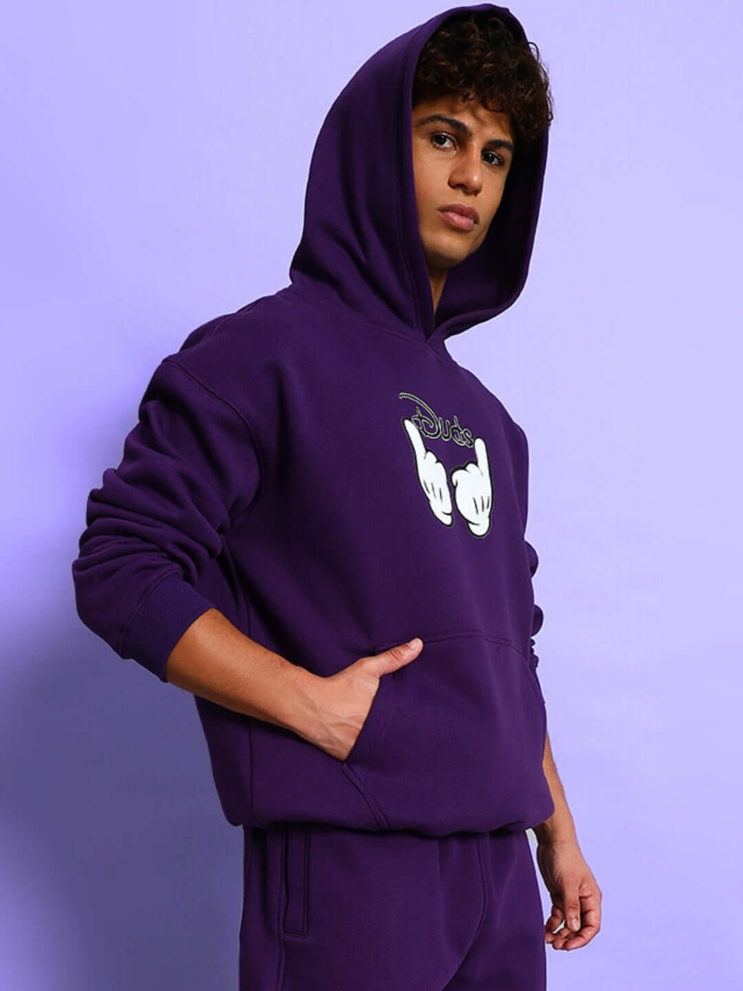 Model wearing SUPREME COTTON FLEECE HOODIE PURPLE, showcasing bold color and unique design.