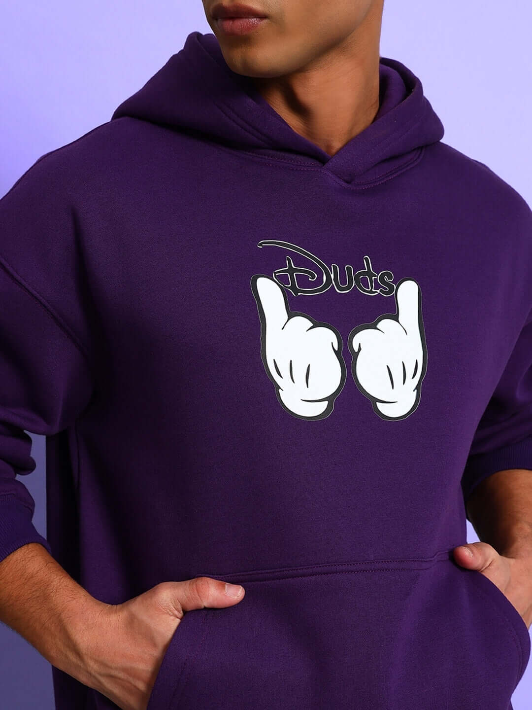 Close-up of a model wearing the SUPREME COTTON FLEECE HOODIE PURPLE with a graphic design on the chest.