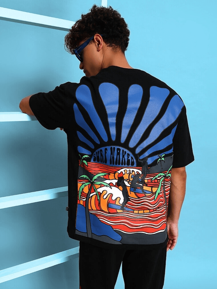 Surf Naked oversized black t-shirt with vibrant beach graphics, made of premium heavy gauge fabric, featuring a mix of cotton and elastane.