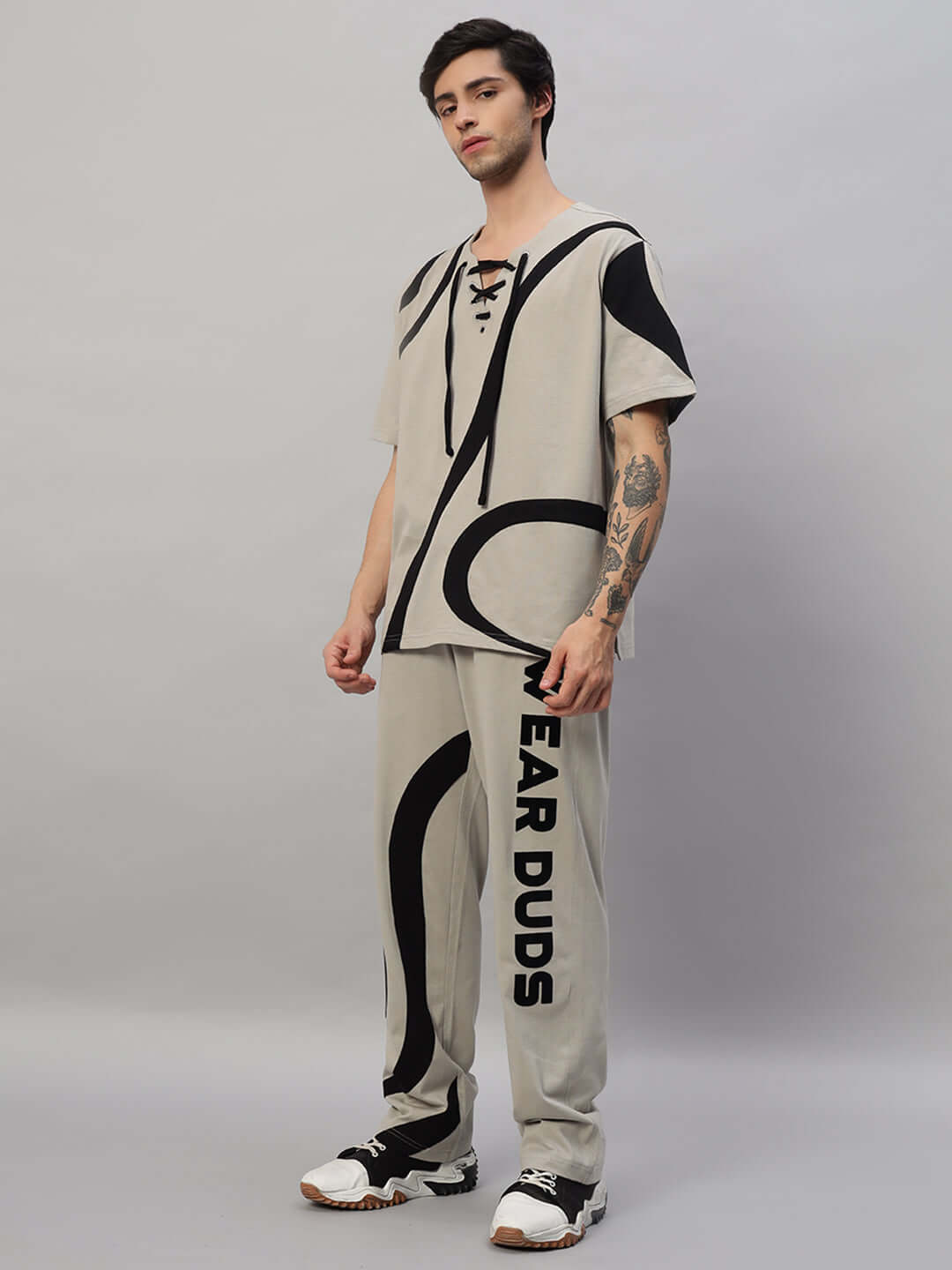 Man wearing SURFING OVERSIZED CO-ORD SET GREY with relaxed fit joggers, elastic waistband, and contrast panel design.