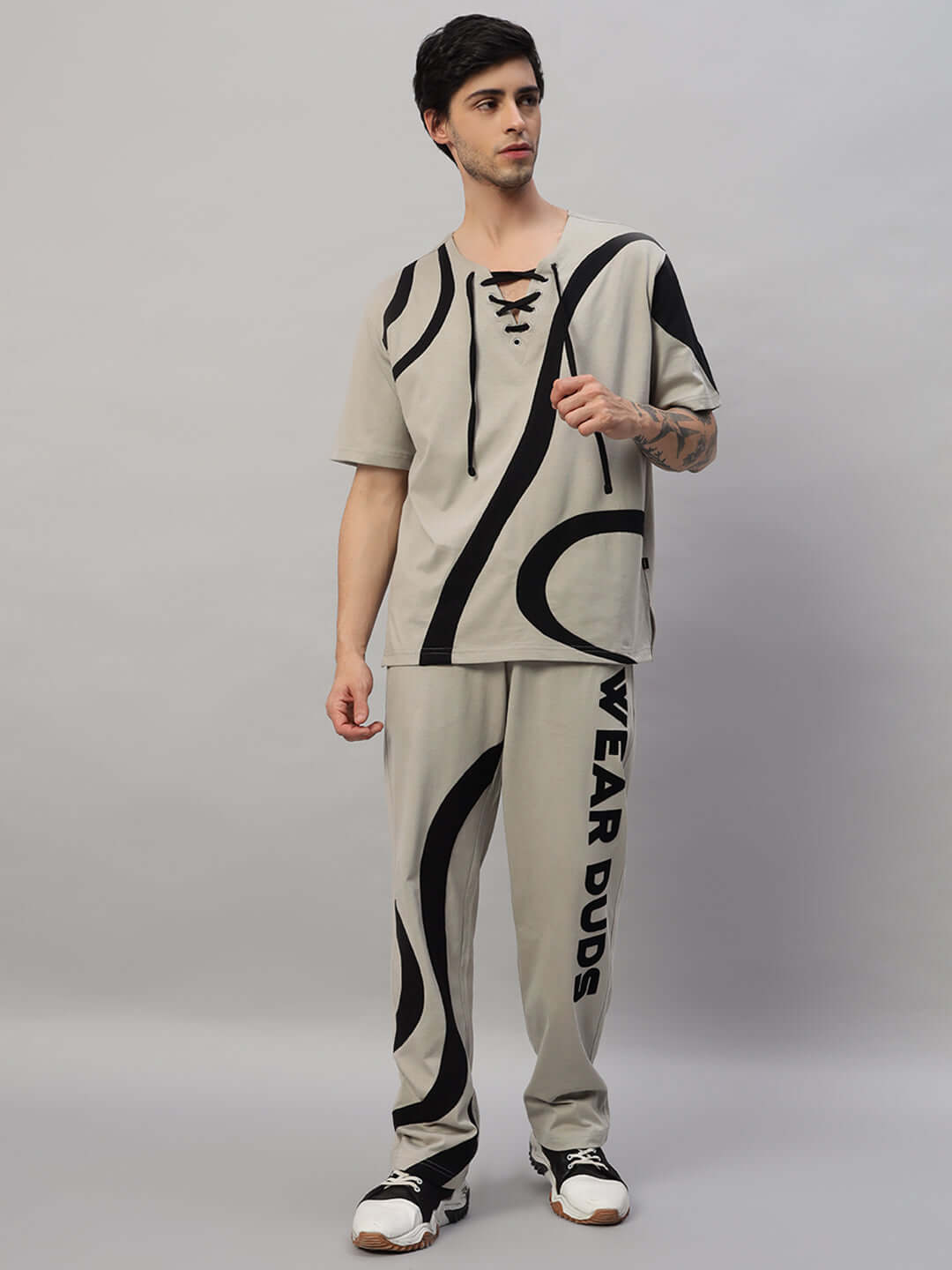 Model wearing grey oversized co-ord set with abstract black pattern and lace detail, featuring relaxed fit joggers by Wear Duds.