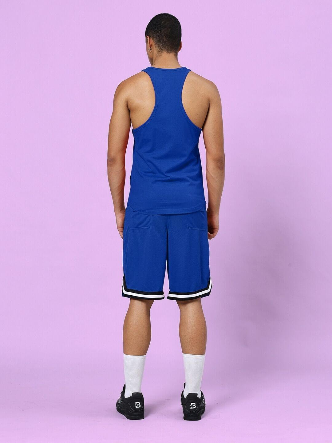 Man wearing TAKE IT EASY GYM CO-ORD SET BLUE, showing back view of the matching set with sleek vest and shorts in vibrant blue.