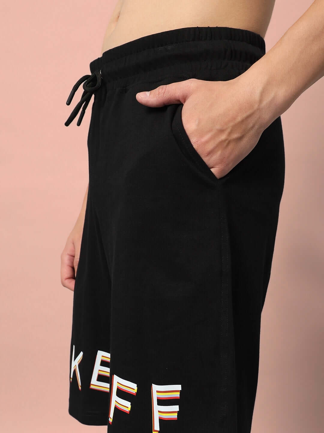 Side view of black TAKE OFF regular fit shorts with pocket and drawstring, showcasing casual wear fashion.