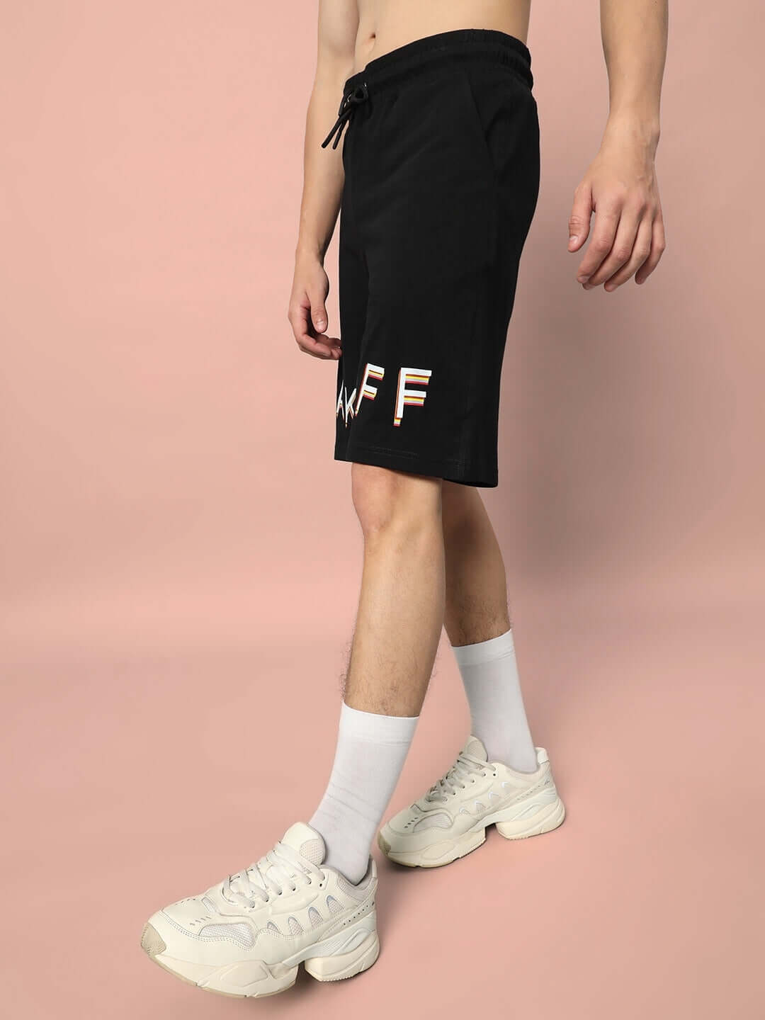 Alt Tag: Model wearing TAKE OFF Regular Fit Black Shorts with customizable sizing option from DUDS.