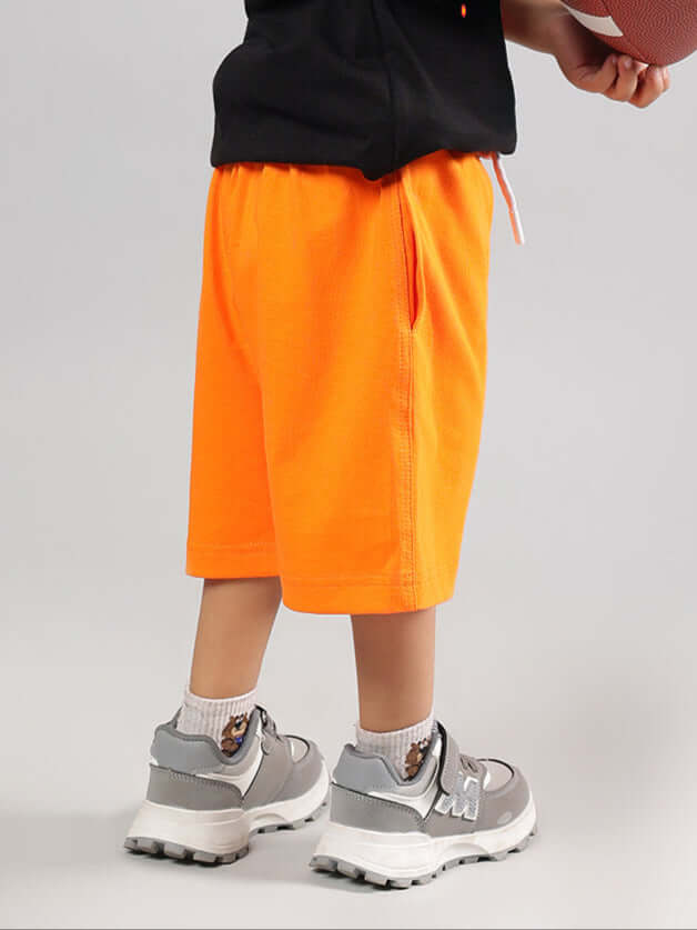 Orange unisex shorts for boys and girls, comfortable and customizable, made by DUDS tailors.