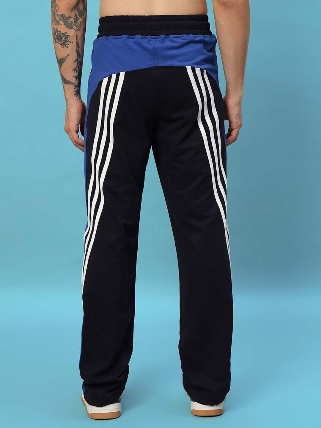 Back view of navy blue Tangle Relaxed-Fit Joggers with white stripes, showcasing custom fit option, made by DUDS tailors.