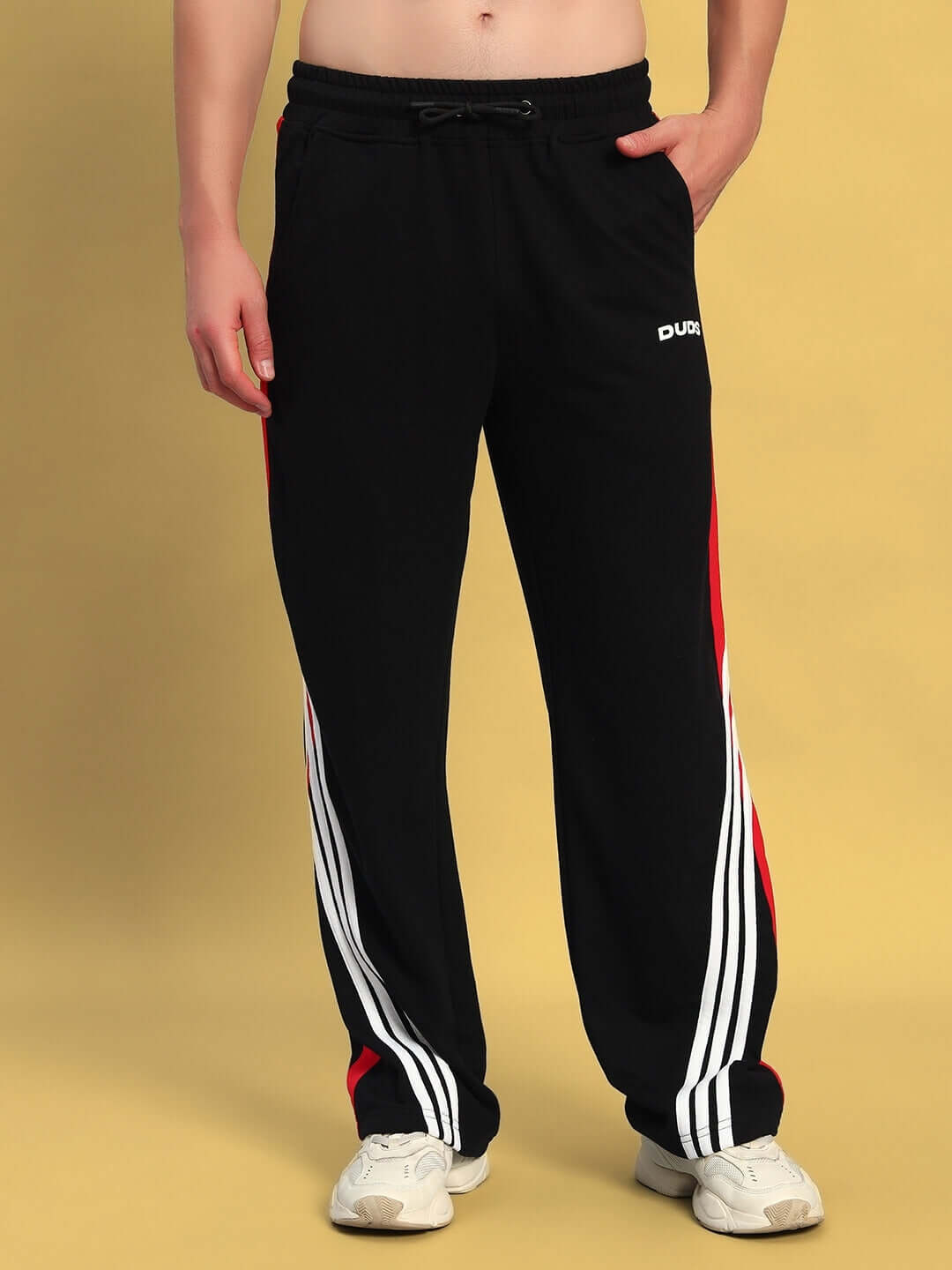 Black-red TANGLE relaxed-fit joggers by DUDS featuring side stripes for a sporty look, worn by a model