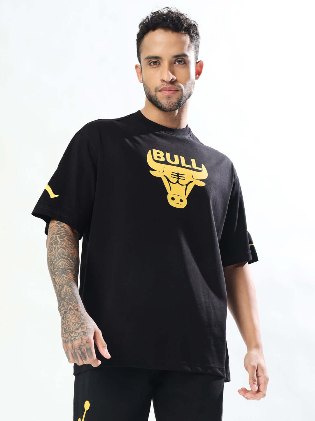 Model wearing a black oversized Taurus t-shirt with bull graphic, available for custom fit at DUDS, emphasizing comfort and style.