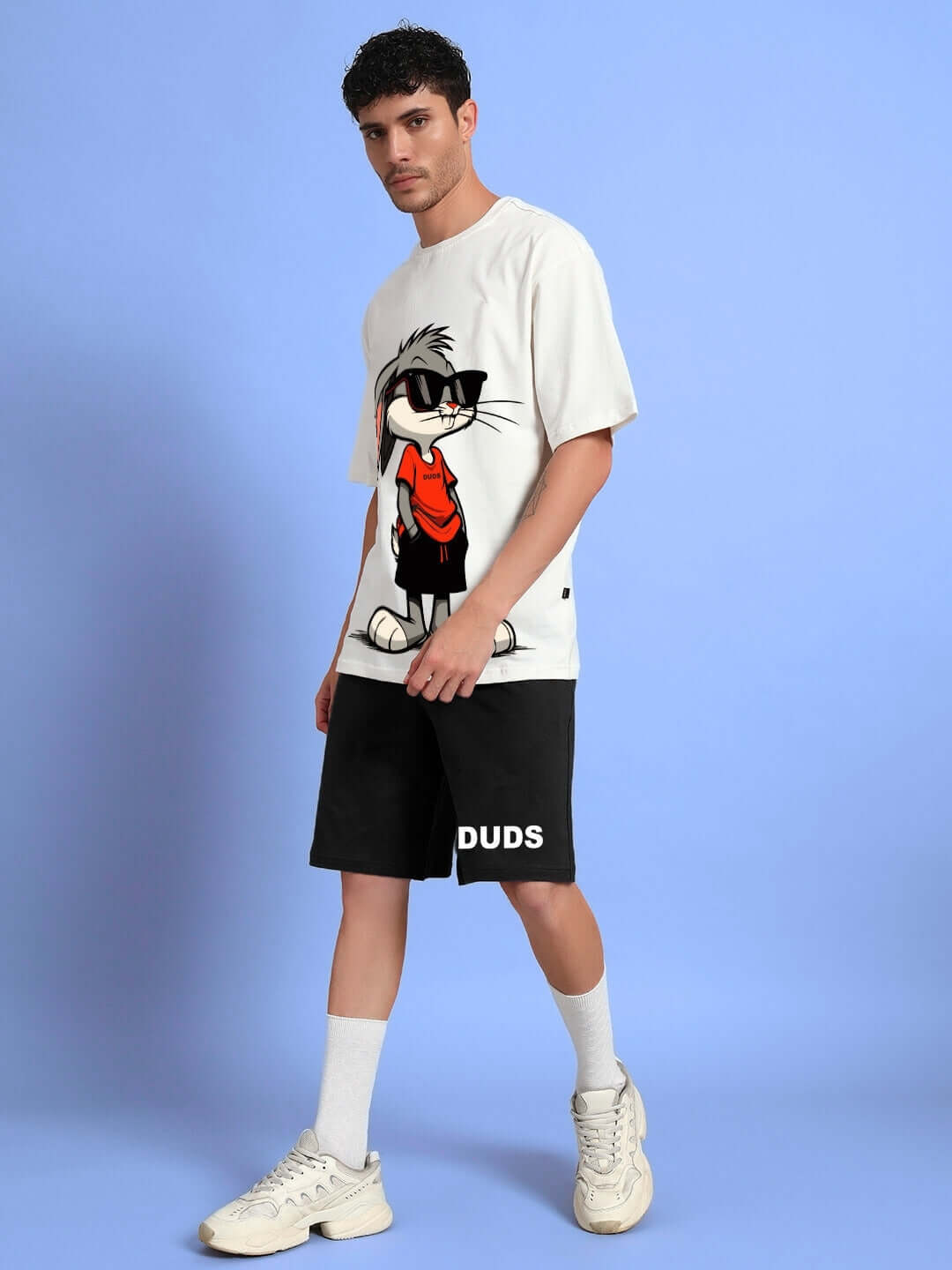 Model wearing THINK BIG BUNNY TOONS CO-ORD SET featuring off-white t-shirt and black shorts, crafted from premium cotton blend fabric.