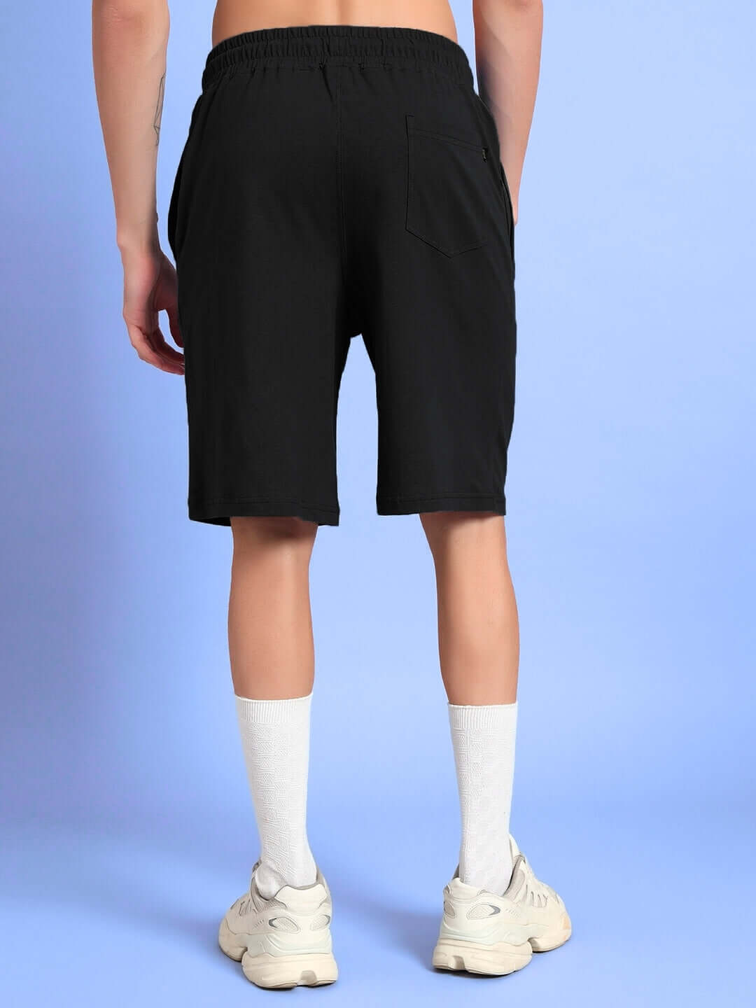 Rear view of THINK BIG summer shorts in black, showcasing a casual fit and comfortable design ideal for summer activities.