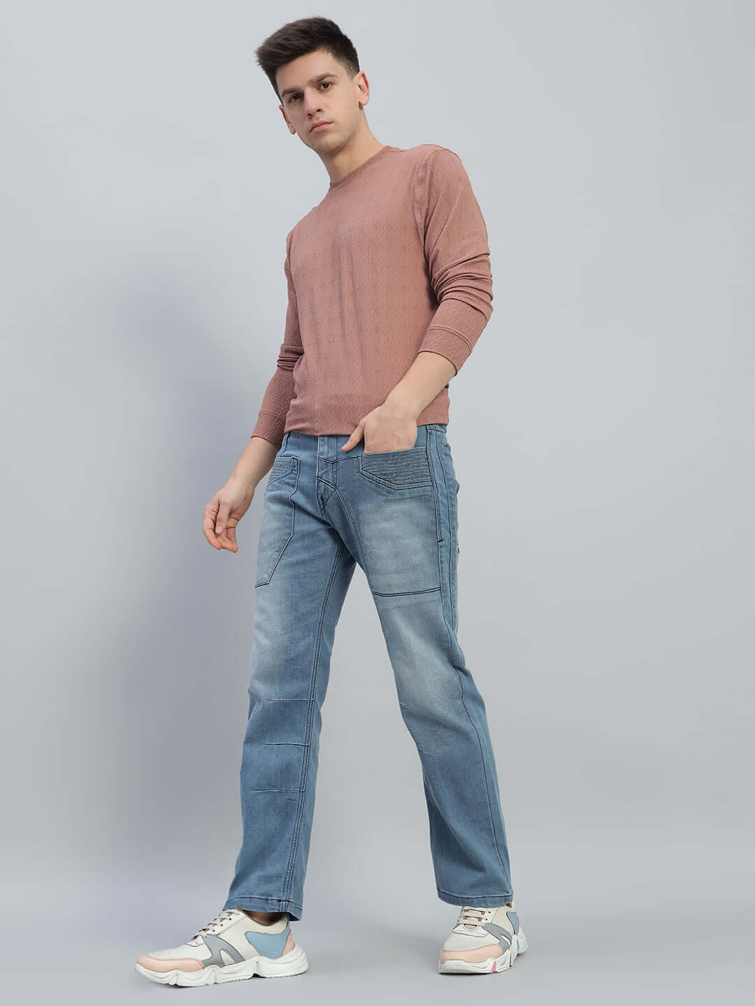 Man wearing Thrifty Regular Fit Denim Jeans (blue), styled with casual shirt and sneakers, showcasing a relaxed fashion look.