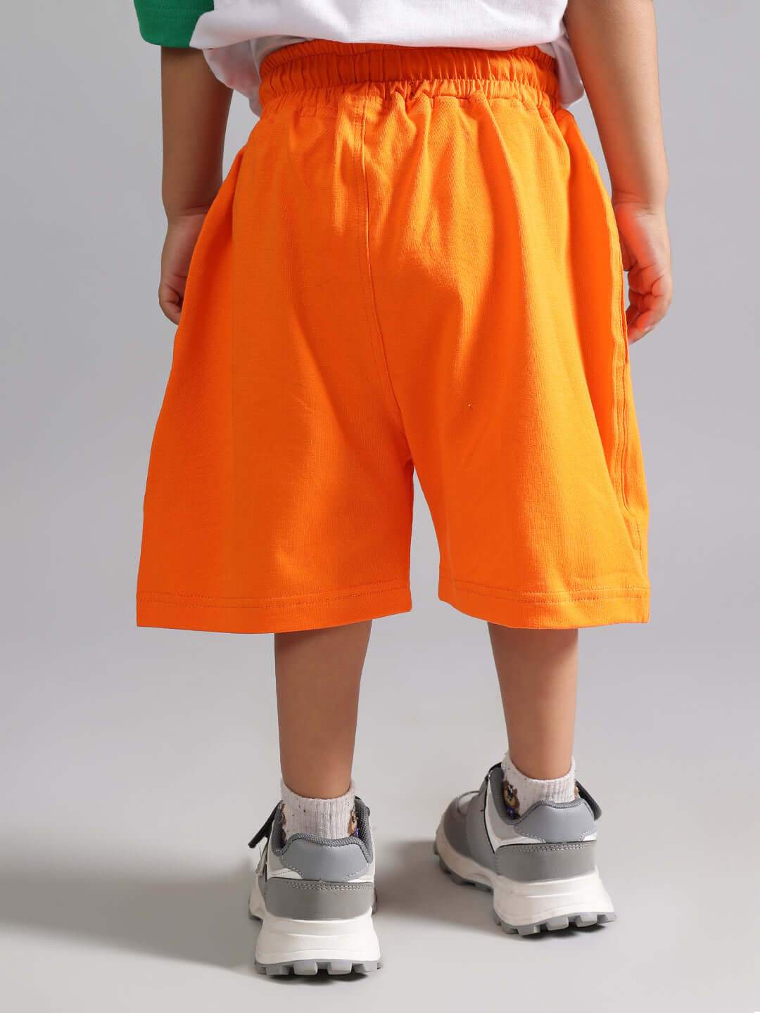 Child wearing bright orange tiger shorts from DUDS, perfect for both boys and girls, showcasing comfortable fit and style.