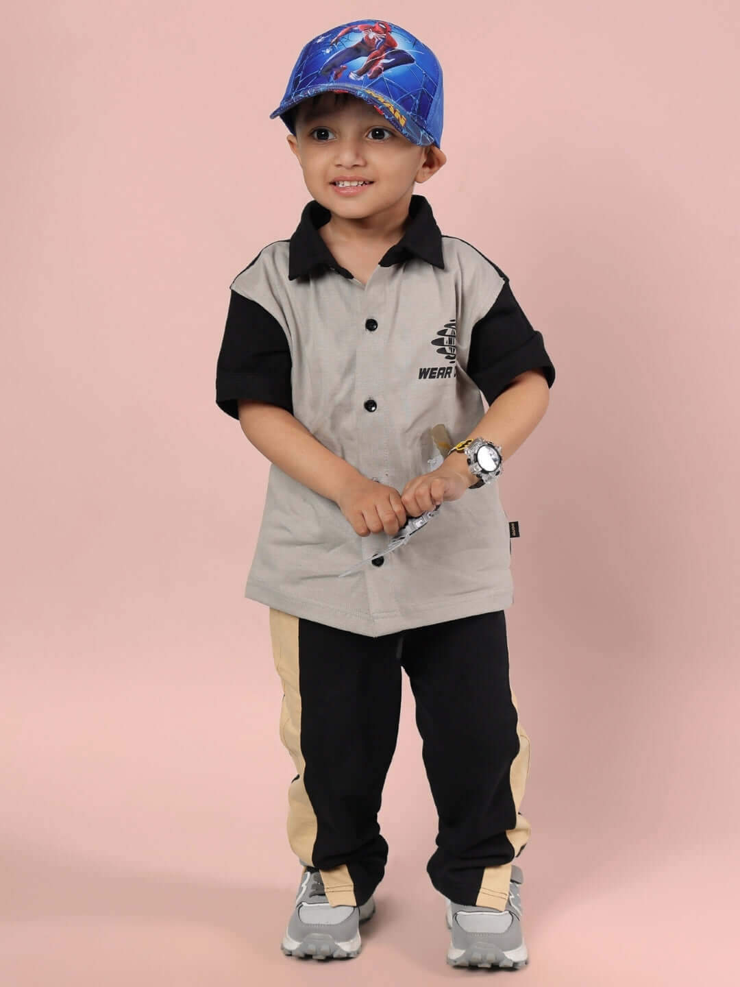 Child wearing TINGE Grey Black Co-ord by DUDS, featuring a shirt and pants set, ideal for both boys and girls.
