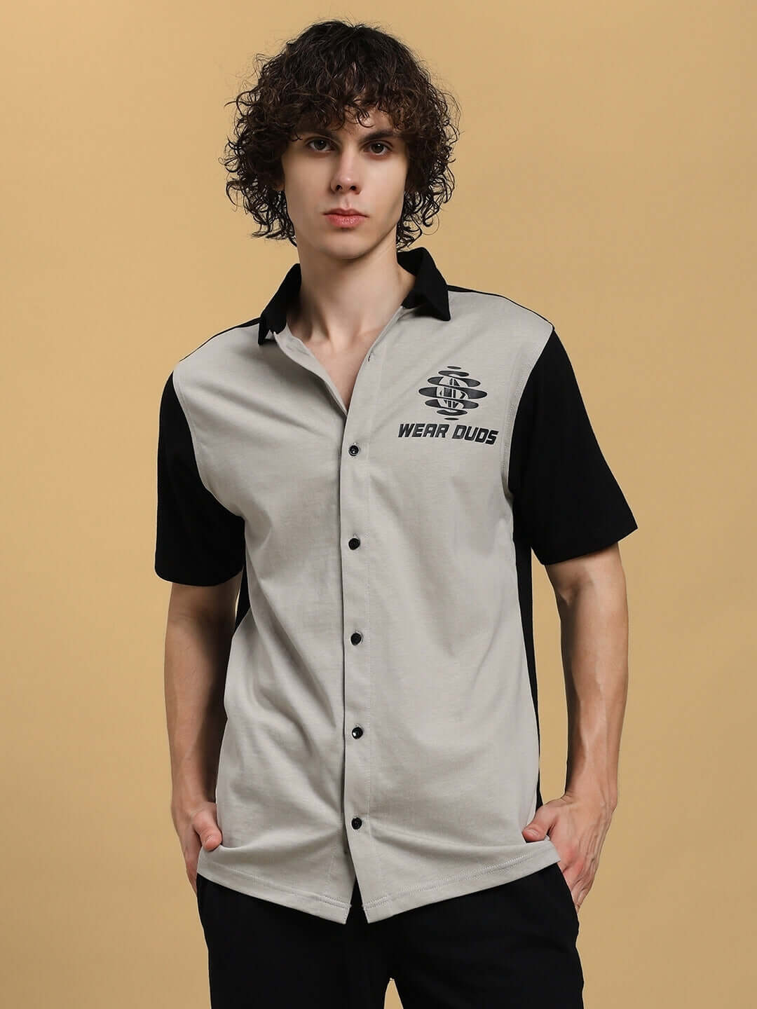 Model wearing TINGE regular fit grey-black shirt by DUDS, short-sleeved with button-up front, custom fit option available.