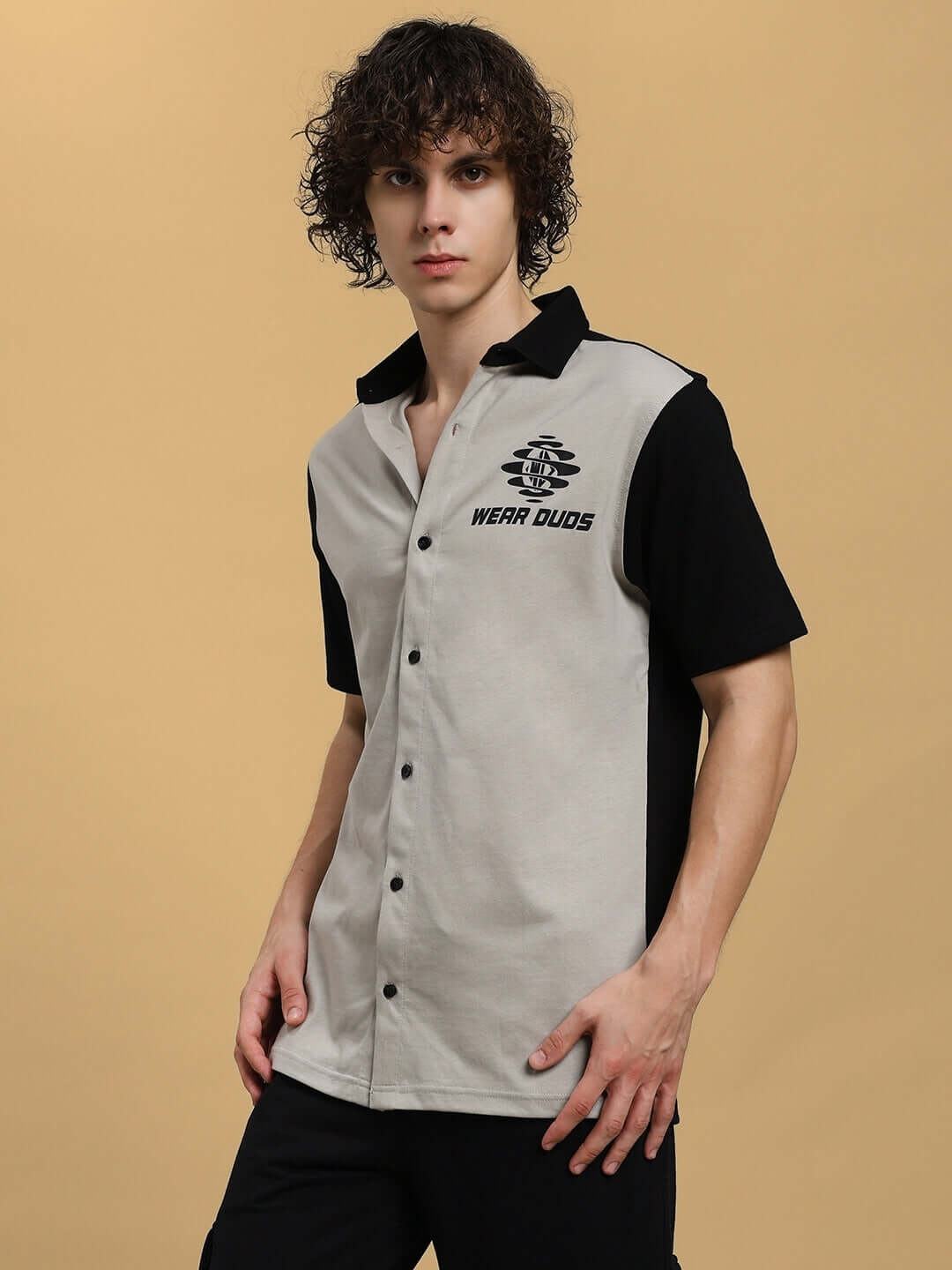 Man wearing a grey-black Tinge regular fit shirt by DUDS with short sleeves and button-up front.