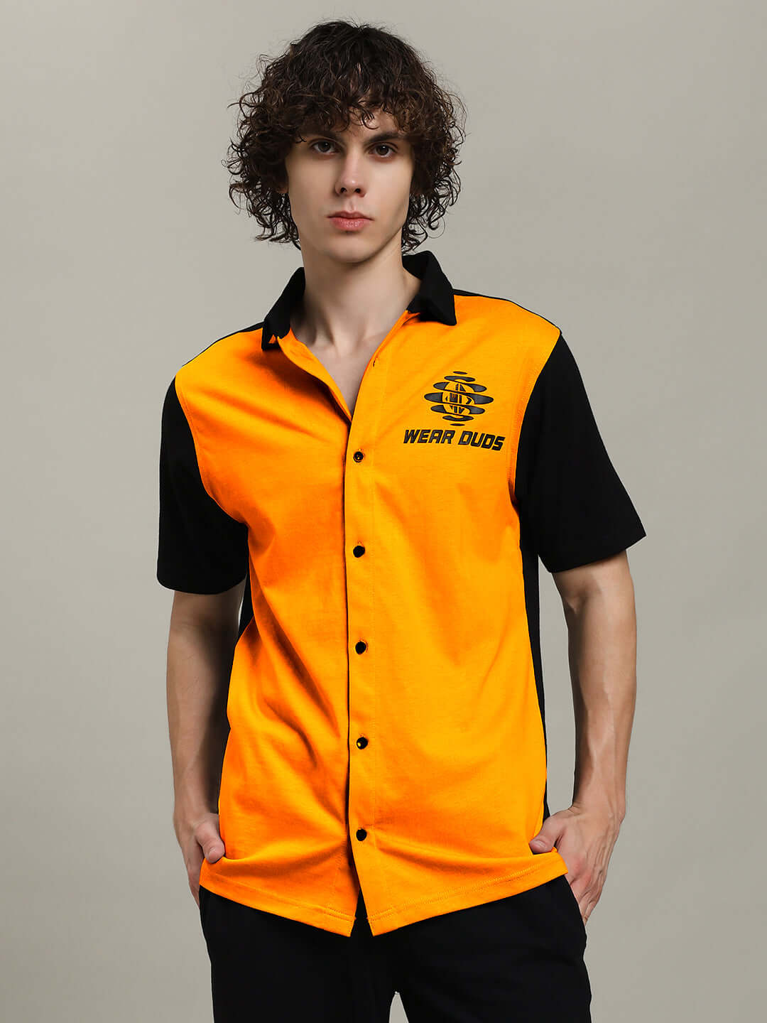 Model wearing Tinge Regular Fit Shirt in orange-black by DUDS, showcasing custom made-to-order fashion with short sleeves and stylish design.