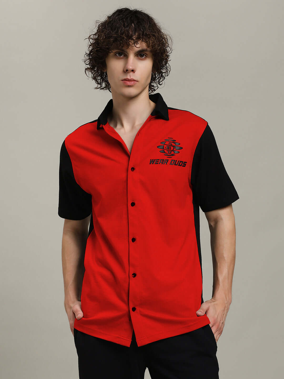 Man wearing a red-black TINGE regular fit shirt made by experienced tailors, showcasing a stylish contrast design suitable for casual wear.