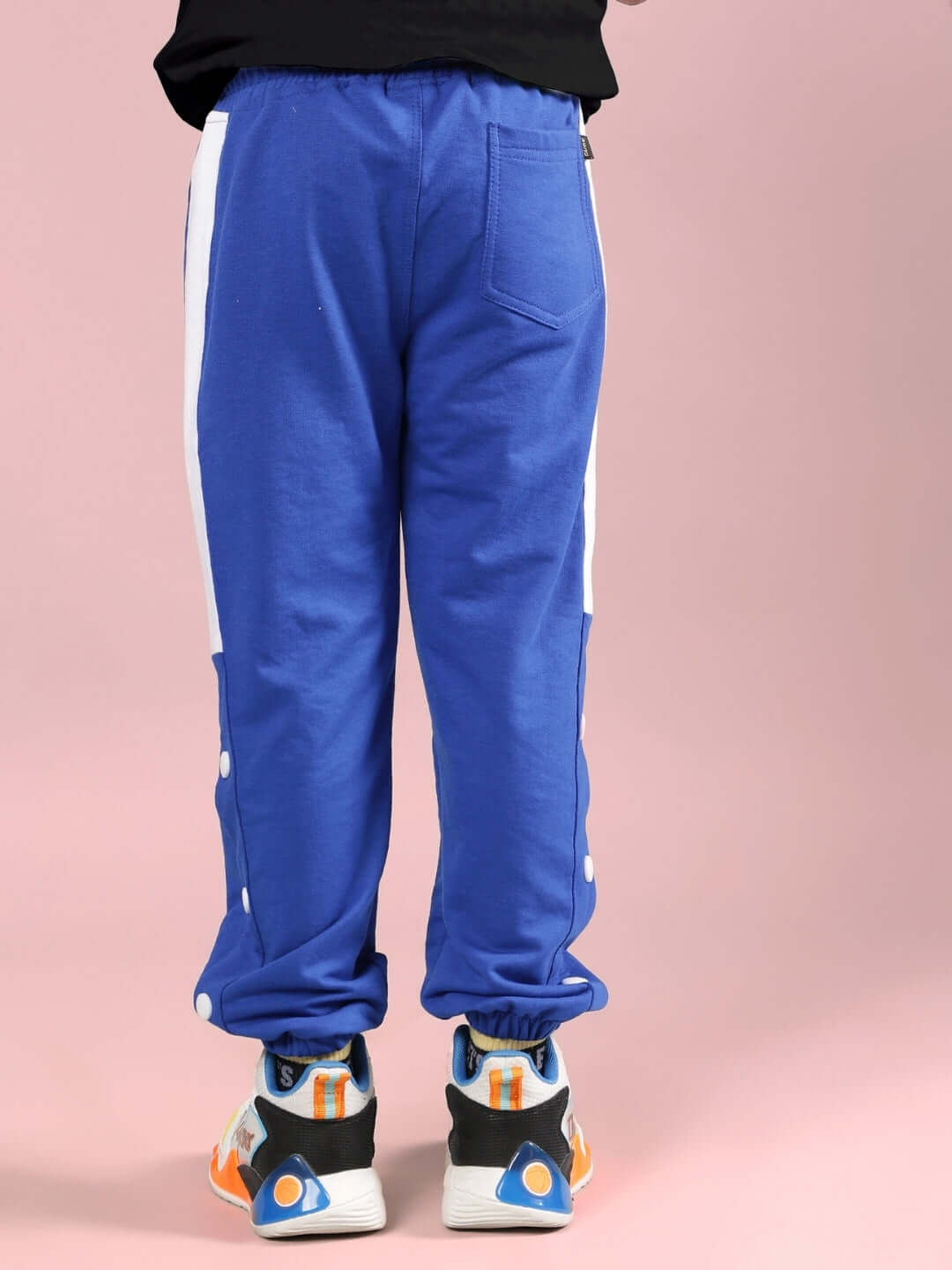 Back view of TINY TOON PRINTED CO-ORD FOR BOYS & GIRLS BLACK-R BLUE showing blue pants with white stripes.