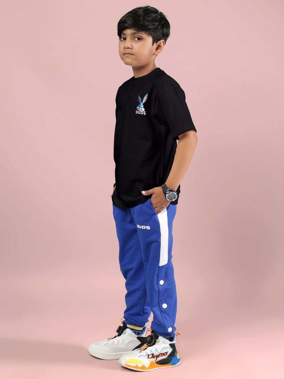 Child wearing TINY TOON PRINTED CO-ORD FOR BOYS & GIRLS BLACK-R BLUE with black t-shirt and blue pants.