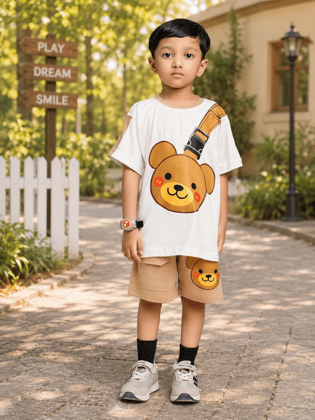 TINY TREND BEAR CO-ORD FOR BOYS GIRLS WHITE BEIGE featuring a boy in a bear graphic tee and beige shorts.
