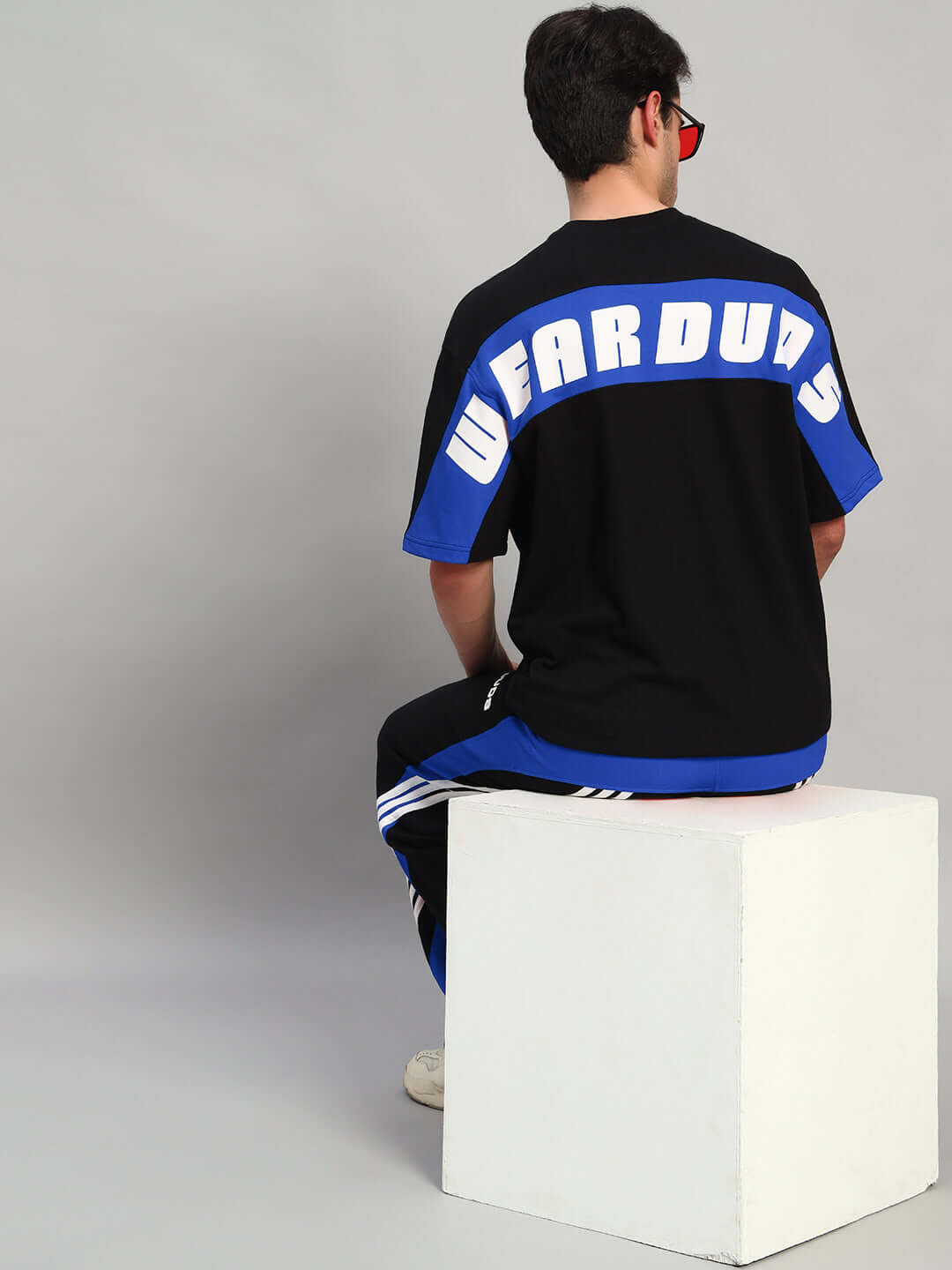 Model wearing TITAN OVER-SIZED T-SHIRT BLACK-BLUE with premium heavy gauge fabric, 97% cotton French terry and 3% elastane, 240 GSM.