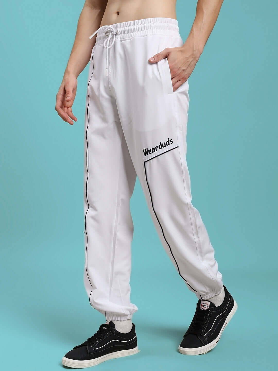 Model wearing Tokyo Relaxed Fit Joggers in white, showcasing side pockets and drawstring waist. Stylish casual wear from DUDS.