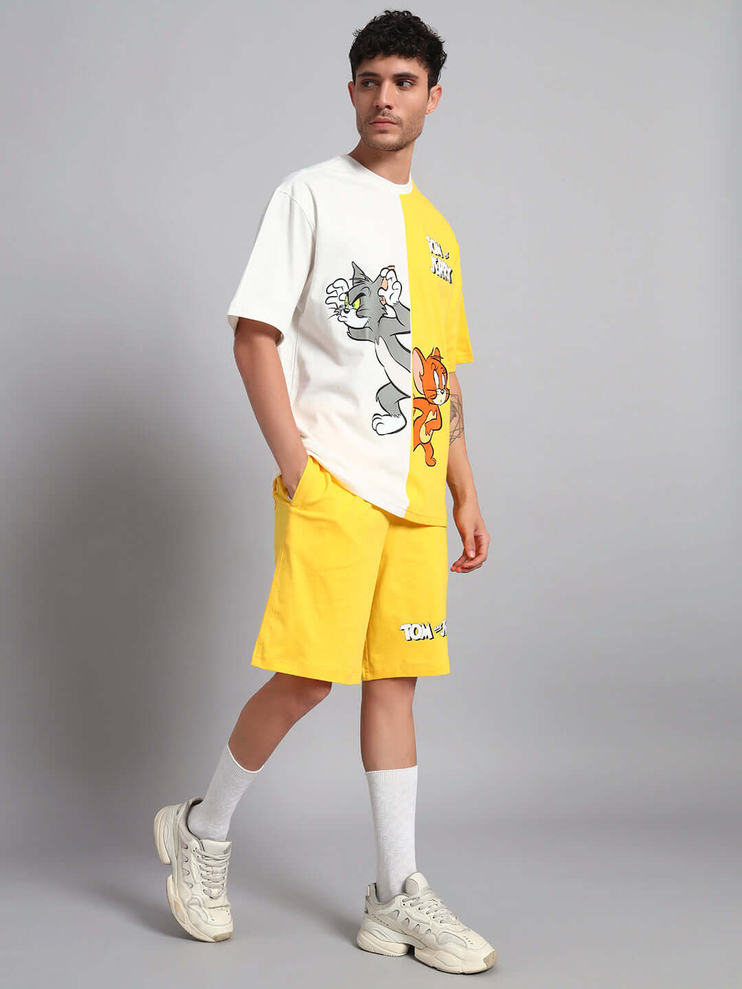 Man wearing Tom & Jerry yellow off-white co-ord set, featuring premium cotton French terry fabric and playful cartoon design.