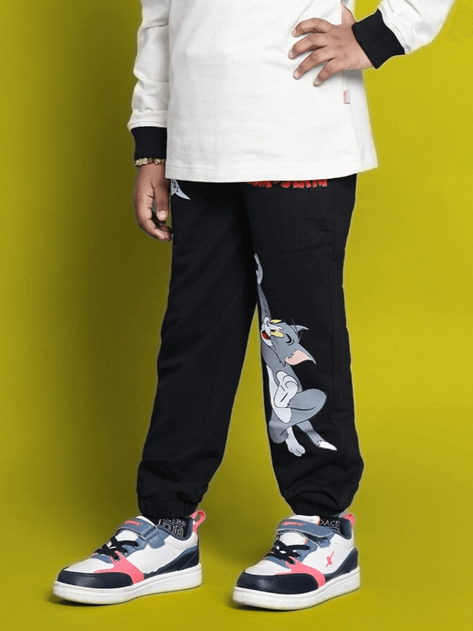 Child wearing TOM & JERRY Jogger in black, featuring a playful cartoon design, ideal for both boys and girls.