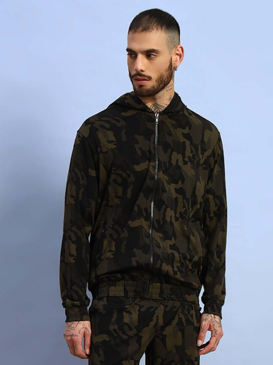 Camo green trench jacket with a hood, modeled by a person against a blue background. Designed by DUDS, available for custom fit.