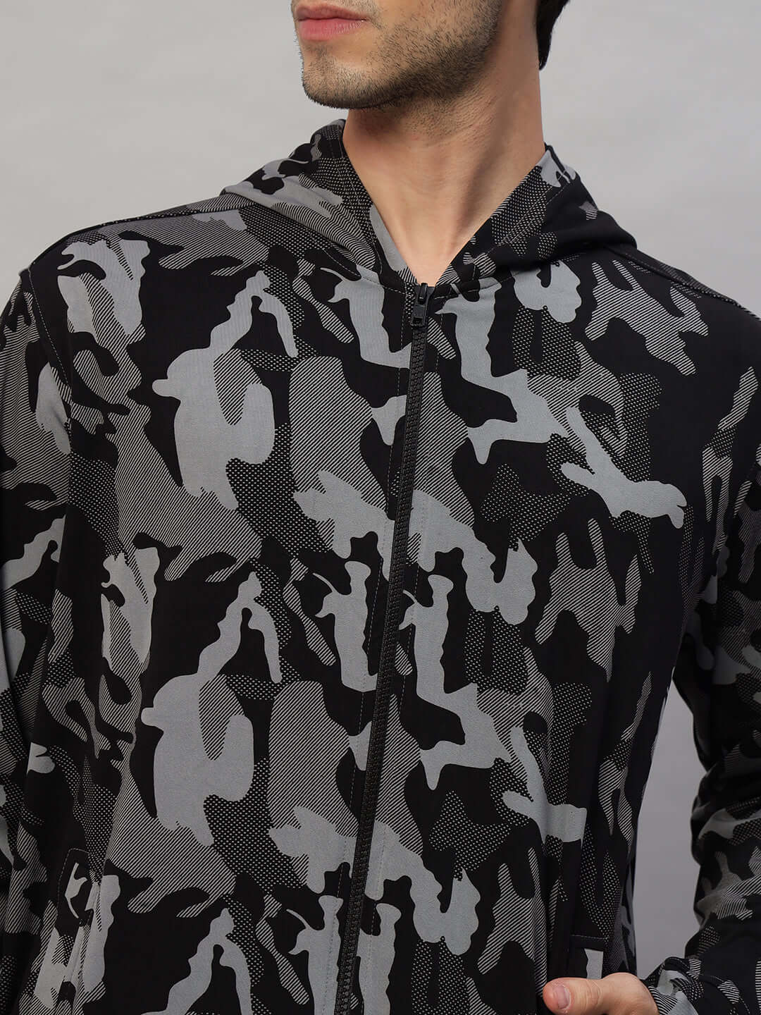 Close-up of a camo navy trench jacket from DUDS, highlighting the camouflage print in black and gray tones, worn by a male model.